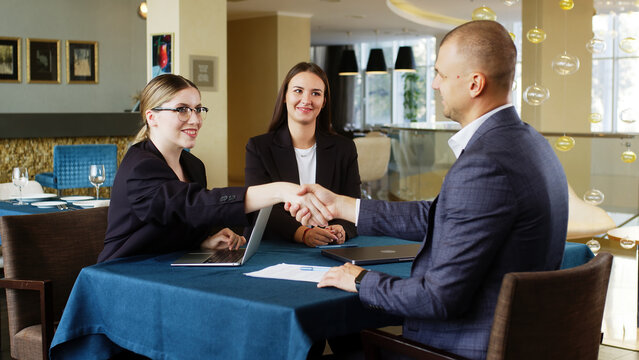 A team of business statisticians analyzes market segments using sales statistics presented in infographics. Trading experts use data charts on paper in the office lobby