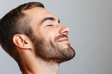 Obraz premium A close up of a man's face with his eyes closed