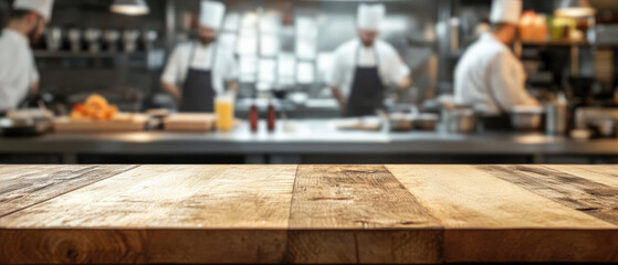 Beautiful wooden table top with a blurred background of a busy kitchen and a chef working in a restaurant or cafe