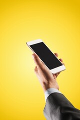 Human hand holding smart phone with a blank screen