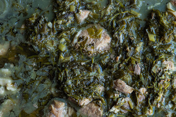 Traditional Georgian spring dish Chakapuli with meat, green plums and herb mix