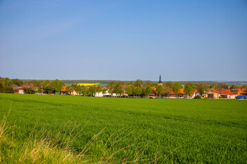 Obraz premium Agra field with a village in the background blurred