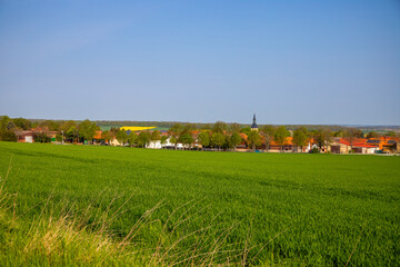 Agra field with a village in the background blurred