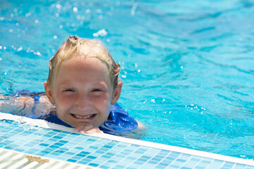 A little girl swimming in the pool