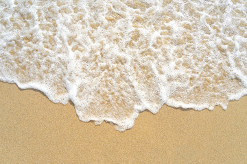 Waves on the golden sandy seashore