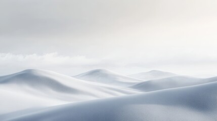 A serene landscape of soft, rolling snow-covered hills under a light sky.