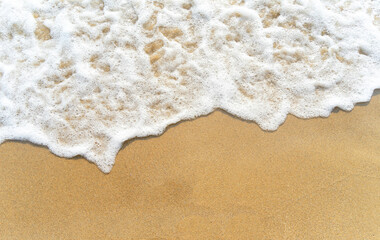 Waves on the golden sandy seashore