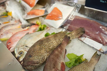Frozen fresh fish among a pile of cold ice cubes, fresh fish seafood in market