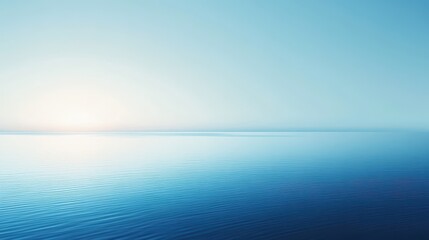 A serene seascape with calm waters and a soft blue gradient sky at sunrise.