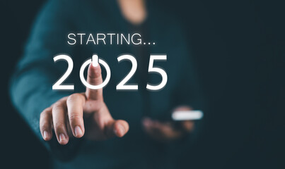 Happy new year 2025, Businessman pressing the start button for 2025 on virtual screen. Concept of planning, start, career path, business strategy, opportunity and change.