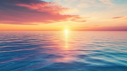 Obraz premium A serene sunset over calm ocean waters, reflecting vibrant colors in the sky.