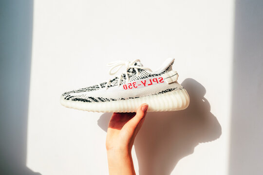 Zagreb Croatia - 14 August 2024: Girl's hand holding Adidas Yeezy BOOST 350 sneakers