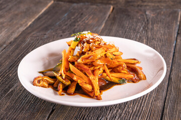 Spicy Pig Ear Salad Dish on wood table. Chinese food. wooden sticks, soy sauce