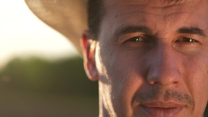 A farmer faces a swarm of mosquitoes and a midge. Mosquito skin insect concept. A person bites a midge while a mosquito eats it. A person bites a sunlight midge while a farmer is out in the field.