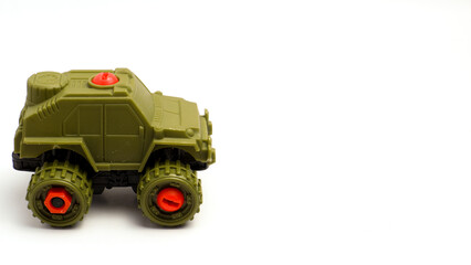 Children's Toy Car In The Shape Of A Military War Tank In Green Color On White Background Isolated, Photographed With Composition Leaving Space On The Right Side