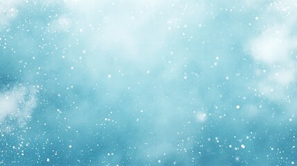 Obraz premium A serene winter background with soft snowflakes falling against a blue backdrop.