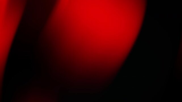 Abstract red and black gradient background with a smooth, flowing design.