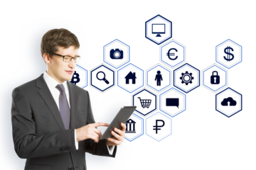 Businessman in a suit using a tablet with blue virtual holographic icons floating on a white background, representing digital data