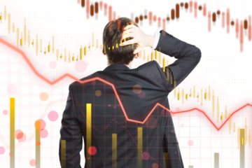 Businessman facing away, analyzing stock market graphs with declining trends on a white background. Concept of financial crisis, business decision making