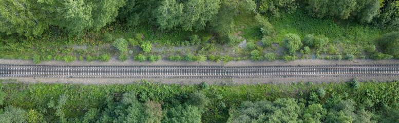Fototapeta premium Railway Tracks Passing through Green Forest, Top View