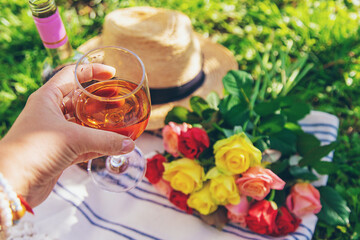 Wine flowers picnic in the garden woman. Selective focus.