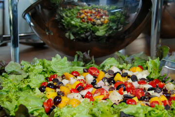 salad tray with various fruits, greens and cold vegetables