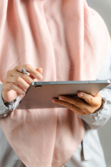 Close up of business muslim woman using tablet doing business task on, tax, report, accounting, statistics, and analytical research