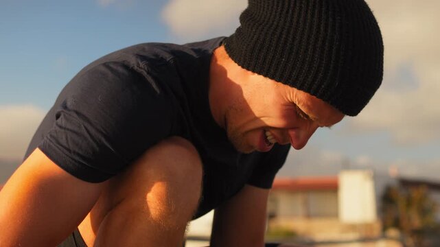 Young athlete in hat preparing for training outdoors. Determined man in sportswear getting ready for workout represents healthy lifestyle.