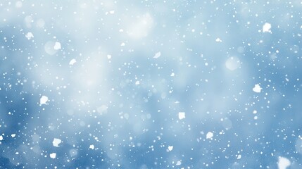 Fototapeta premium A serene winter scene with softly falling snowflakes against a blue background.