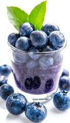 Fresh blueberries in a glass cup, vibrant color with green leaf, perfect for healthy recipes and desserts.