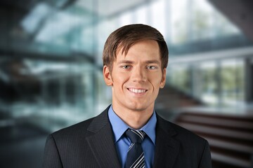 Happy professional business man posing in office.