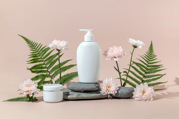 cosmetics containers on a stone podium surrounded by fern leaves and chrysanthemums