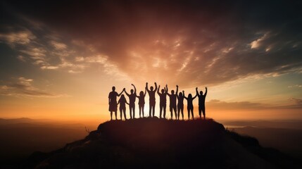 Group of people in silhouette holding hands on a hilltop 