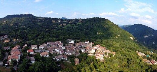 Aerial view of the village of Talada with the Bismantova stone in the background. Cervarezza, Ventasso, Reggio Emilia, Italy