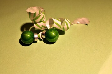 green Christmas balls making a bow, beautiful Christmas card.