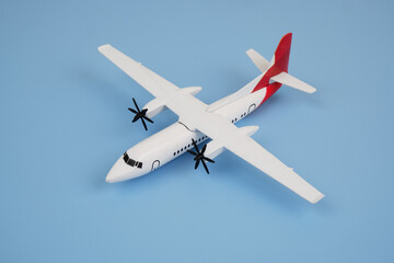 Airplane model on blue background.  Travel and transport concept.