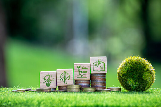 Carbon credit and CO2 emission reduction concept. Wooden cubes with CO2 icon on stack of silver coins and green globe with world map. Tax credits for enterprises to stop global warming process.