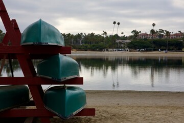 canoes stacked on the beach boat rack