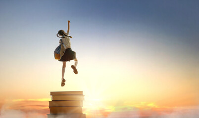 child on the tower of books