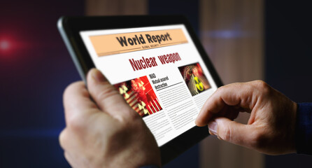 Nuclear weapon newspaper on mobile tablet screen