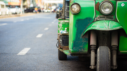Naklejka premium Tuk Tuk car parking on road Bangkok city tradition travel
