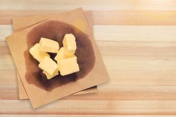 Tasty butter cubes on wooden desk