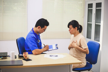 Fototapeta premium Male doctor with experience examining young pregnant women