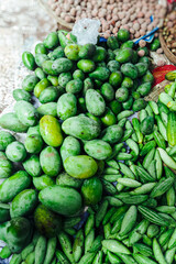 Assorted Fresh Green Mango Pointed Gourd Cucumber Vegetables Displayed in a Local Market