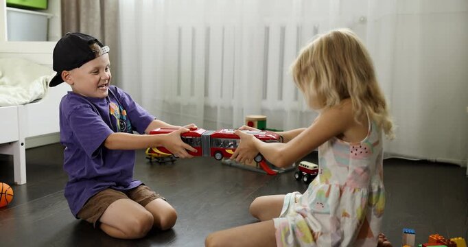 children are fighting over a toy. conflict between sister and brother. sibling relationships