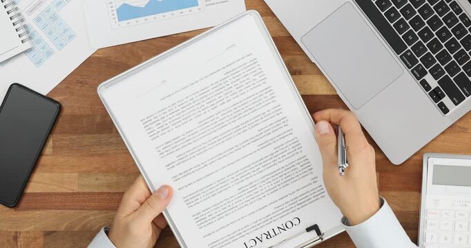 Agent reviewing legal contract at desk top view