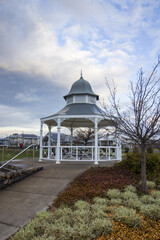 This photograph features a charming white wooden gazebo with grey roof at Central Park Bowral Southern Highlands New South Wales Australia