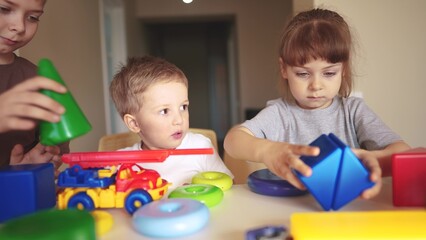 kindergarten. a group of children play toys cubes and cars on the table in kindergarten. kid dream creative lifestyle happy family preschool education concept. nursery baby toddler home