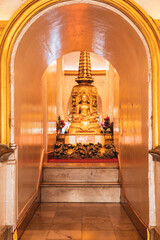 golden buddha statue and shrine in a temple in bangkok
