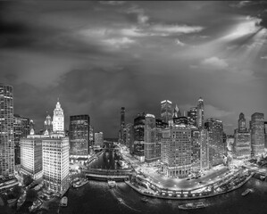 Black and white aerial view of Chicago skyline along Chicago River on a summer night